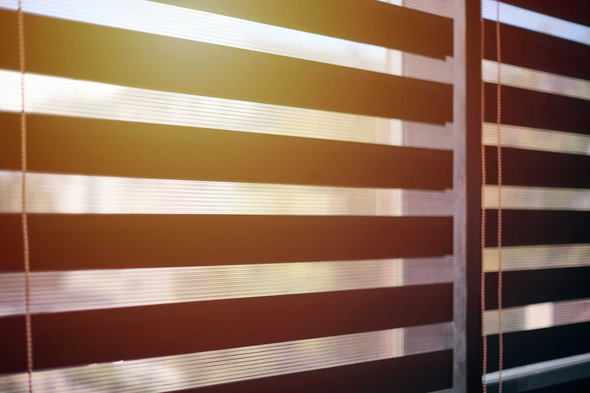 Office blinds. Sunlight through modern fabric blinds. Office meeting room lighting range control.