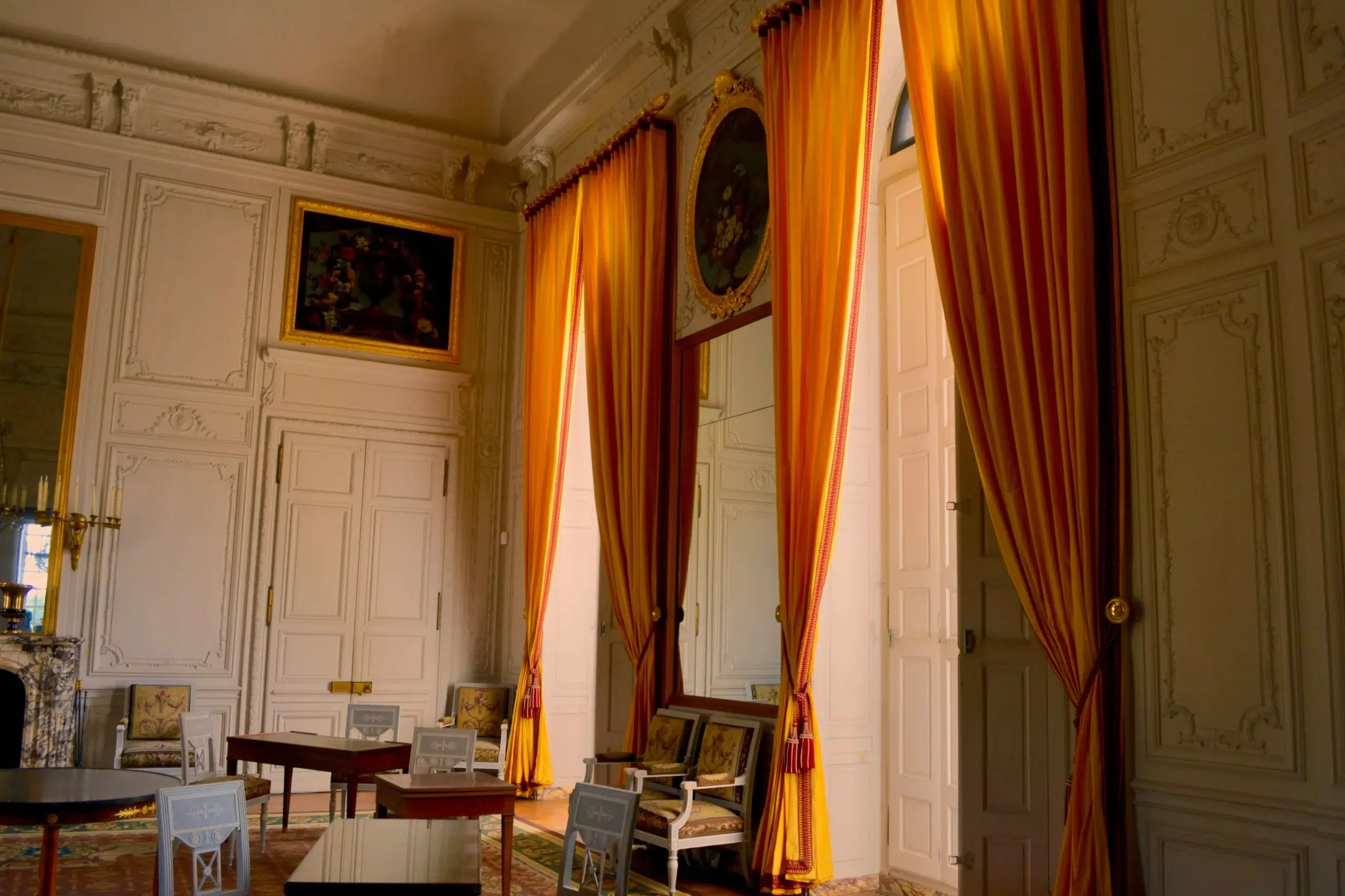 Living room with orange curtains and light coming through